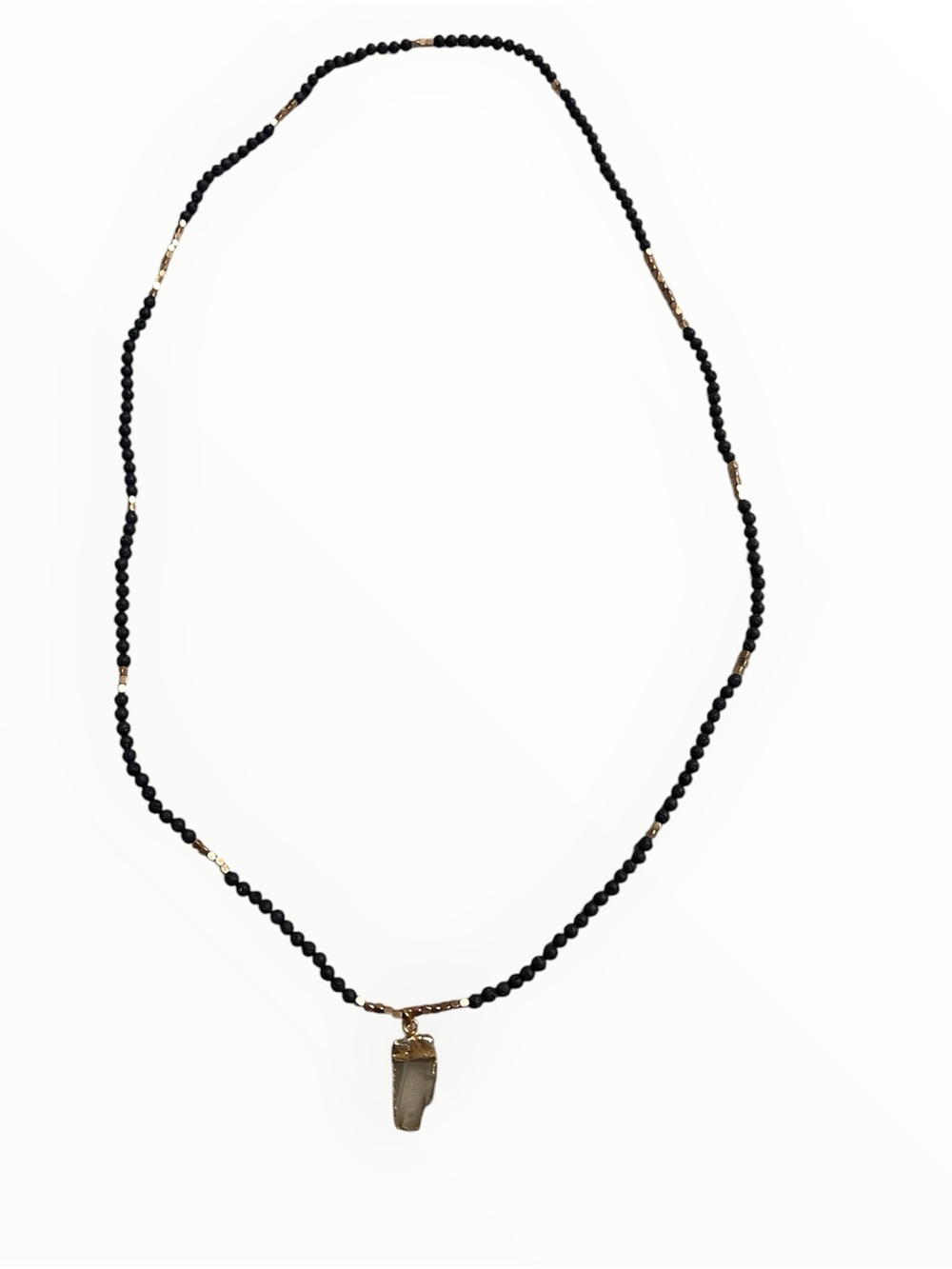 Long black lava stone and gold tone beaded necklace with raw quartz pendant